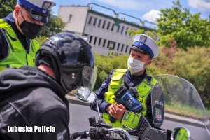 policjanci kontrolują motocyklistę